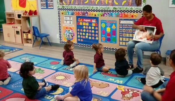 Teacher showing a picture to preschoolers