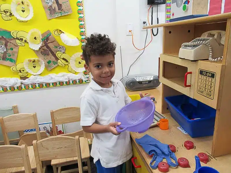 Preschool Boy Playing with Toy Kitchen